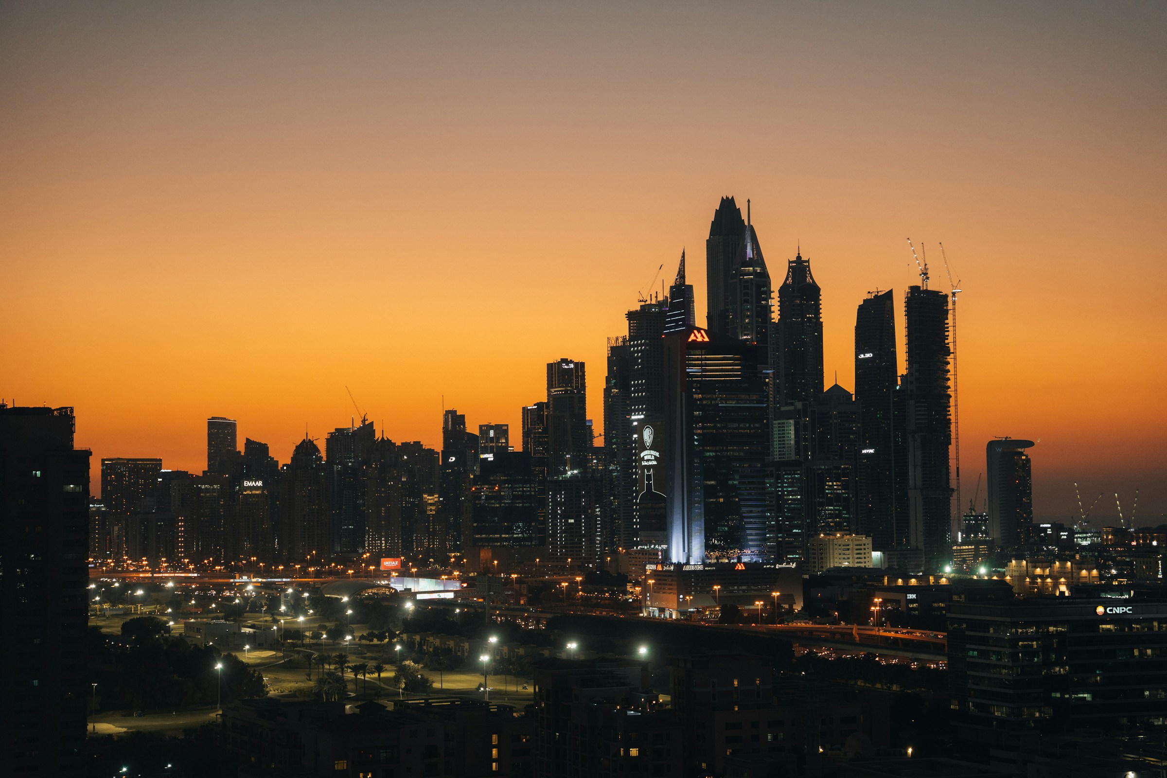Dubai towers silhouetted against a golden sunset